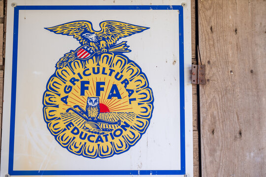 Hawkeye Point, Iowa, USA - 6.21.2025: FFA emblem displayed on a rustic wooden wall at a community agricultural event in early summer