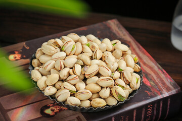 Roasted Pistachios in Metal Bowl - Healthy Nuts Snack with Open Shells Showing Green Interior
