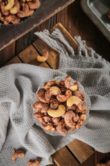 Baked Cashew Nuts with Salt and Crispy Skin in Glass Bowl on Rustic Wooden Table