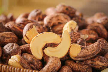 Roasted Cashew Nuts Close-Up - Healthy Snack Food with Cracked Shells Showing Creamy Kernels Inside