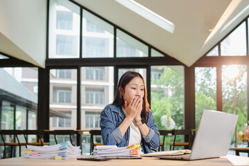 Asian businesswoman is working in office. She is very excited and happy that his business is...