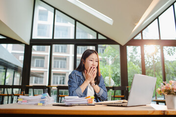 Asian businesswoman is working in office. She is very excited and happy that his business is...