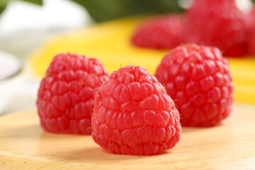 Fresh Red Raspberries on Wood Surface with Shallow Depth of Field