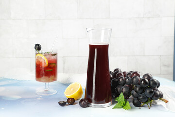 Fresh Grape Juice and Cocktail with Dark Grapes and Lemon on White Background