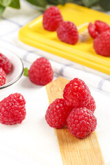 Fresh Red Raspberries on Wooden Cutting Board - Healthy Berry Fruit with Shallow Depth of Field