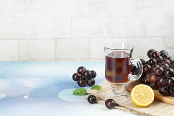Fresh grape juice drink with fruits and mint on wooden cutting board - summer refreshment beverage...