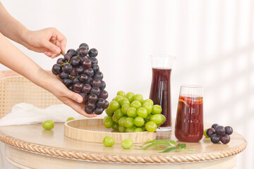 Fresh Grape Juice with Green and Purple Grapes on Wooden Tray - Summer Drinks and Healthy Lifestyle