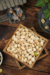 Roasted Pistachios in Wooden Box on Rustic Wood Table - Healthy Nuts Snack Food Photography