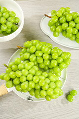 Fresh Green Grapes in White Bowls on Wooden Table - Healthy Organic Fruit