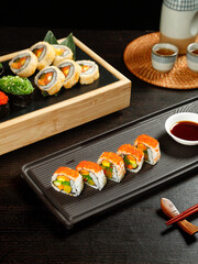 Traditional Japanese Sushi Rolls with Seaweed Rice and Vegetables on Bamboo Platter