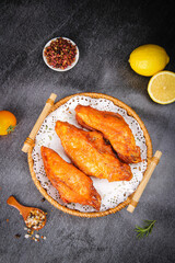 New Orleans Style Chicken Wings with Szechuan Spices and Lemon on Dark Slate Background