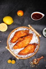 Orleans Glazed Chicken Fillets with Szechuan Specialties and Citrus on Dark Stone Surface