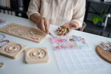 Senior mature older asian woman Art hobby handmade making beads jewellery accessories handcraft...