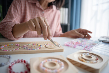 Senior mature older asian woman Art hobby handmade making beads jewellery accessories handcraft...