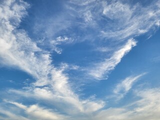 Obraz premium Azure Canvas: A breathtaking vista of a clear blue sky adorned with wisps of cloud, capturing the ethereal beauty of nature's artwork. 