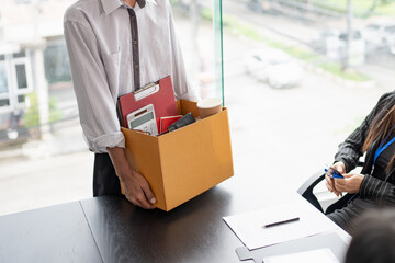 Business man sending resignation letter to boss and Holding Stuff Resign Depress or carrying...
