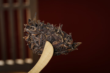 Traditional Dried Tea Leaves on Wooden Spoon for Tea Ceremony