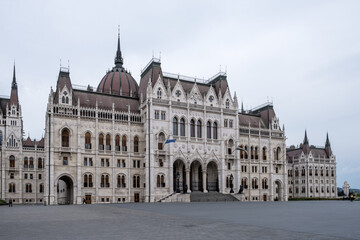 Budapest, Hungary – Architectural detail of the Hungarian Parliament Building (Országház), showcasing Neo-Gothic ornamentation, pointed arches, spires, and intricate stone carvings.