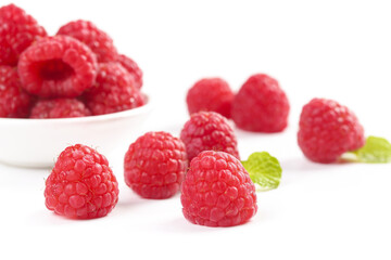 Fresh Red Raspberries on White Background with Bowl and Mint Leaves