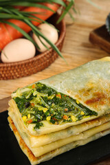Homemade Vegetable Pie with Leek and Greens Filling on Wooden Table with Fresh Ingredients