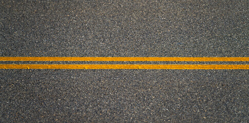 double yellow lines on new paved asphalt road surface