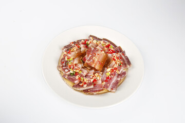 Sliced Bacon and Pancetta Cold Cuts on White Plate with Spices and Herbs