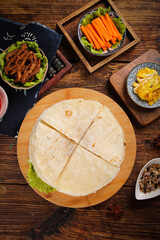 Fresh Tortilla Wraps with Mixed Vegetables and Grilled Meat Breakfast Preparation on Rustic Wooden Table