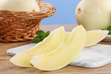 Fresh Honeydew Melon Slices from Yanliang Shaanxi China on Wooden Cutting Board with Basket