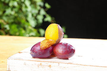 Fresh Australian Prunes with Golden Flesh on Wooden Board - Imported Stone Fruits