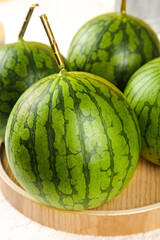 Hainan Yellow Flesh Watermelons - Fresh Selenium-Enriched Small Specialty Fruits in Wooden Bowl