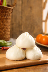 Freshly Steamed Xiao Long Bao Chinese Soup Dumplings on Wooden Cutting Board