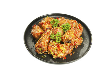 Fried Pork Ribs with Garlic and Peppers on Black Plate - Asian Cuisine Dish