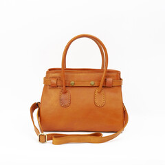 Beautiful tan colored feminine leather bag isolated on white background. Perfect for leather product catalog design.