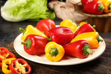 Colorful Fresh Red and Yellow Bell Peppers Collection on White Plate