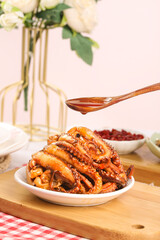 Spicy Marinated Squid Tentacles with Sauce on Wooden Board - Cooked Seafood Appetizer