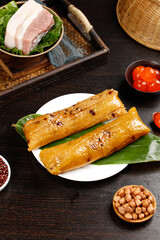 Traditional Chinese Rice Dumplings with Salted Egg Yolk and Pork on Wooden Table