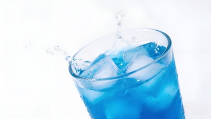 Blue Cold Drink with Ice Cubes Splashing in Glass on White Background