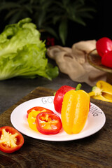 Fresh Colored Bell Peppers Display with Deep Red and Yellow Fruit Vegetables on Kitchen Counter