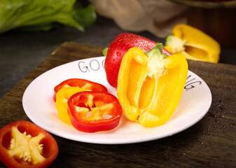 Fresh Colorful Bell Peppers Sliced on Plate - Vibrant Yellow and Red Varieties with Water Droplets