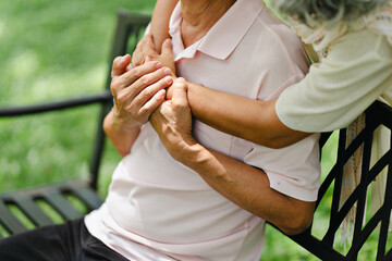 Asian senior couple relaxing together in park