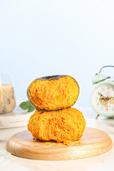 Fresh Cut Pumpkin Half Showing Orange Flesh on Wooden Board in Studio Kitchen Setup