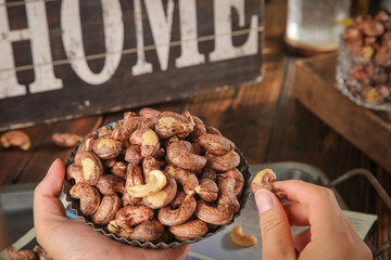 Roasted Cashew Nuts in Bowl with Rustic Home Kitchen Background - Healthy Snack Food Concept