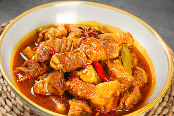 Spicy Braised Beef Brisket Stew with Chili Peppers and Vegetables in Bowl