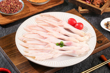 Fresh Raw Duck Feet with Spices and Cooking Ingredients on Kitchen Counter