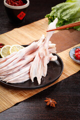 Fresh Raw Duck Meat with Large Feet Prepared for Asian Cooking on Wooden Board