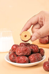Dried Red Jujube Dates from Xinjiang China Cross Section Hand Holding Traditional Healthy Snack Food