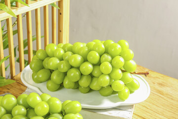 Fresh Green Grapes on White Plate in Sunny Natural Kitchen Setting