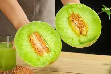 Fresh Green Melon Halves with Seeds Held in Kitchen - Healthy Fruit Close-up