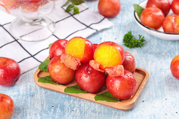 Fresh Red Plums with Golden Flesh on Wooden Plate - Healthy Summer Fruit Display