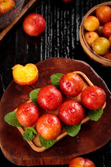 Fresh Red Plums with Water Droplets on Wooden Board - Healthy Organic Stone Fruit